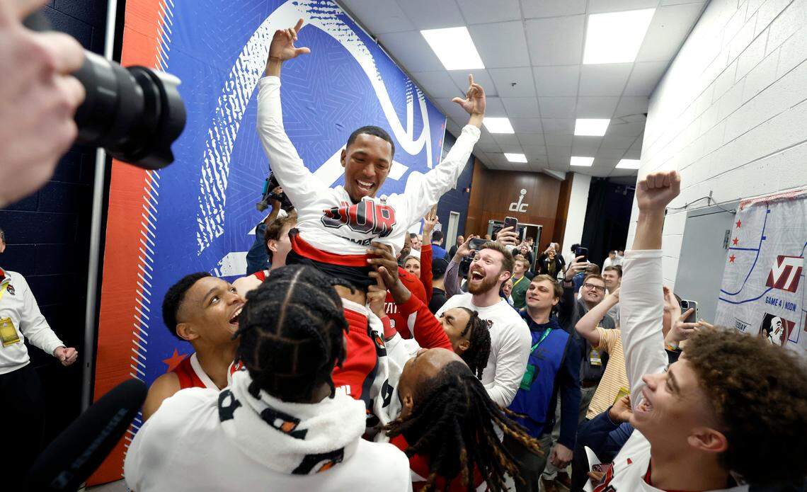 N.C. State’s KJ Keatts (13) is lifted up after placing the Wolfpack sticker on the board after N.C. State’s 74-69 victory over Duke in the quarterfinal round of the 2024 ACC Men’s Basketball Tournament at Capital One Arena in Washington, D.C., Thursday, March 14, 2024.