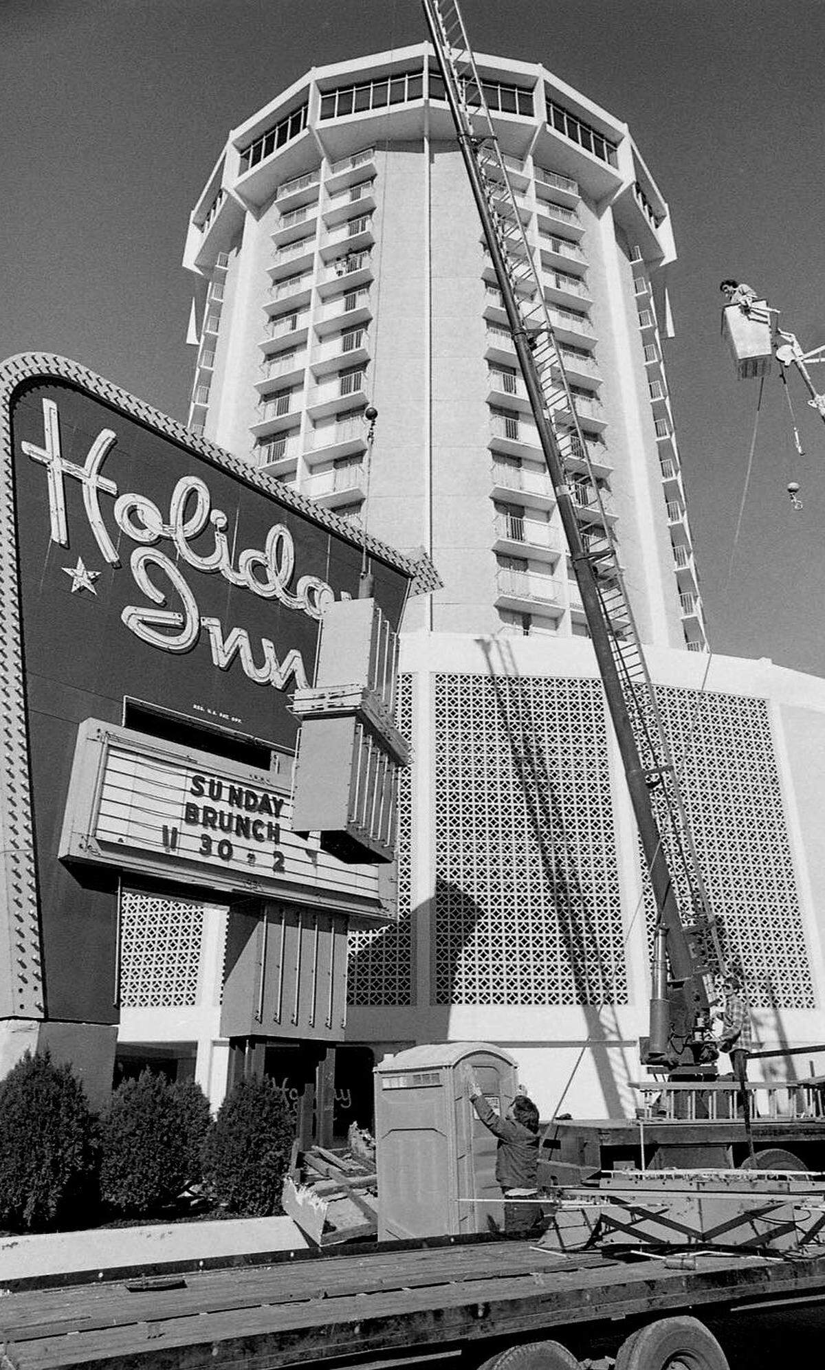 The large illuminated sign at the downtown Raleigh Holiday Inn is taken down Februrary 11,1987.