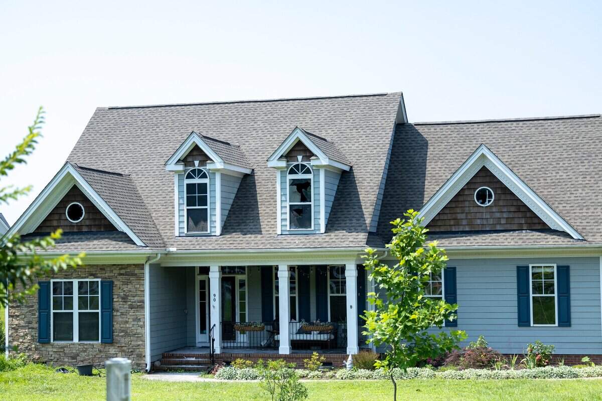 A broken second-story window can be seen a day after emergency personnel responded to a house fire on Rand Road in Raleigh, where three people were found during a search and pronounced dead at the scene Tuesday morning, June 24, 2025, according to a Wake County sheriff’s office spokesperson.