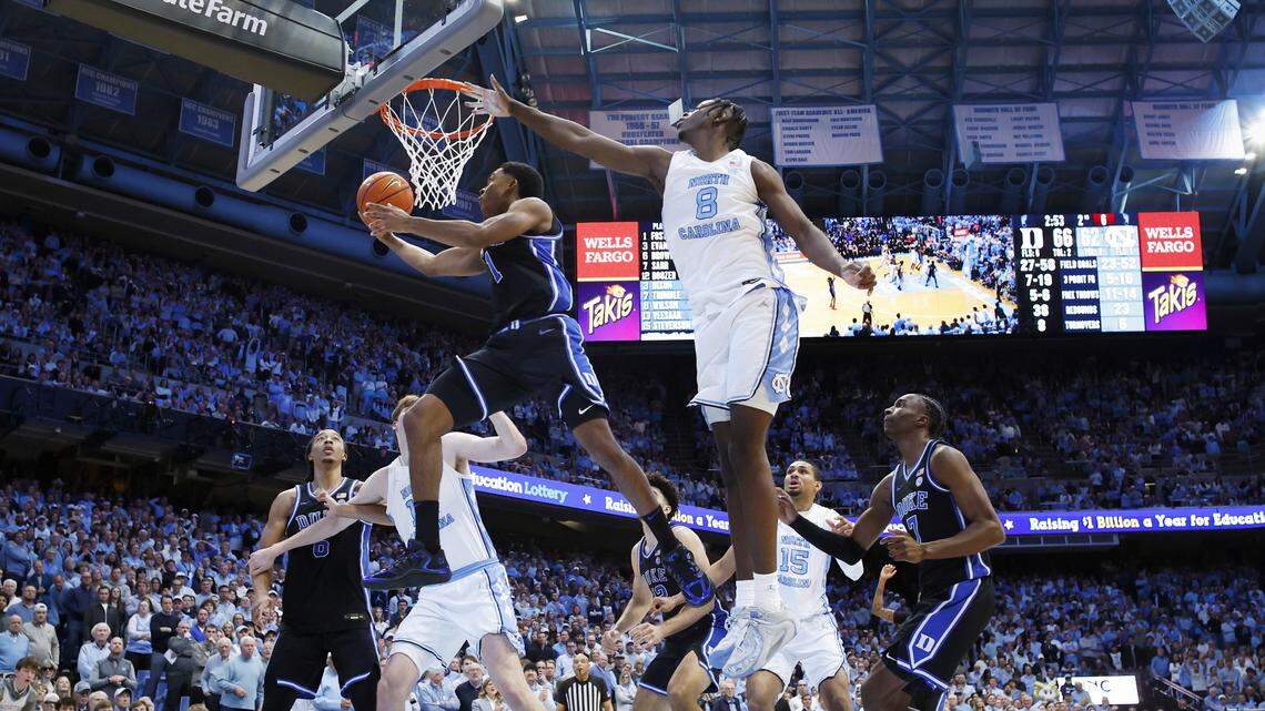 Duke’s Caleb Foster (1) drives by North Carolina's Caleb Wilson (8) during UNC’s 71-68 victory over Duke at the Dean E. Smith Center in Chapel Hill, N.C., Saturday, Feb. 7, 2026.
