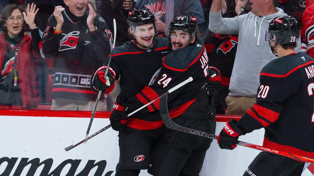 Carolina Hurricanes center Seth Jarvis (24) celebrates his goal with defenseman Dmitry Orlov (7) against the Dallas Stars during the first period at Lenovo Center.