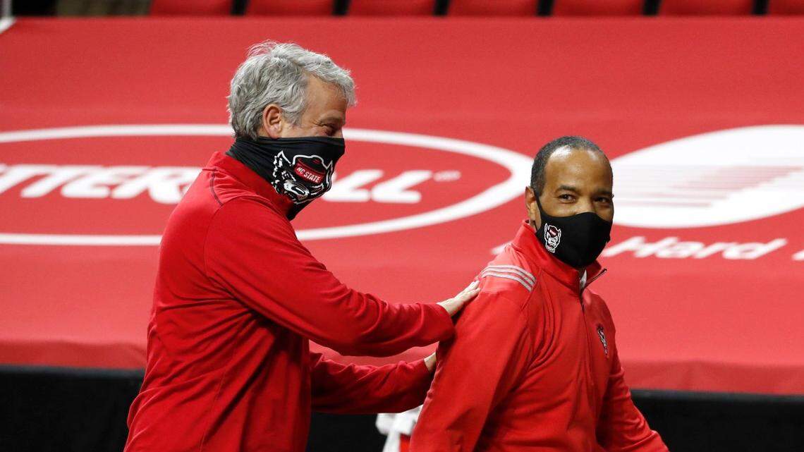 N.C. State Athletics Director Boo Corrigan congratulates head coach Kevin Keatts as they walk off the court after N.C. States 79-76 victory over UNC at PNC Arena in Raleigh, N.C., Tuesday, December 22, 2020.