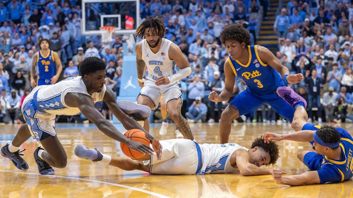 North Carolina forward Drake Powell (9) dives for a loose ball in a massive scramble for control, with 17 seconds to play against Pitt on Saturday, February 8, 2025 at the Smith Center in Chapel Hill, N.C. The Tar Heels held on to a one point lead to defeat Pitt 67-66.