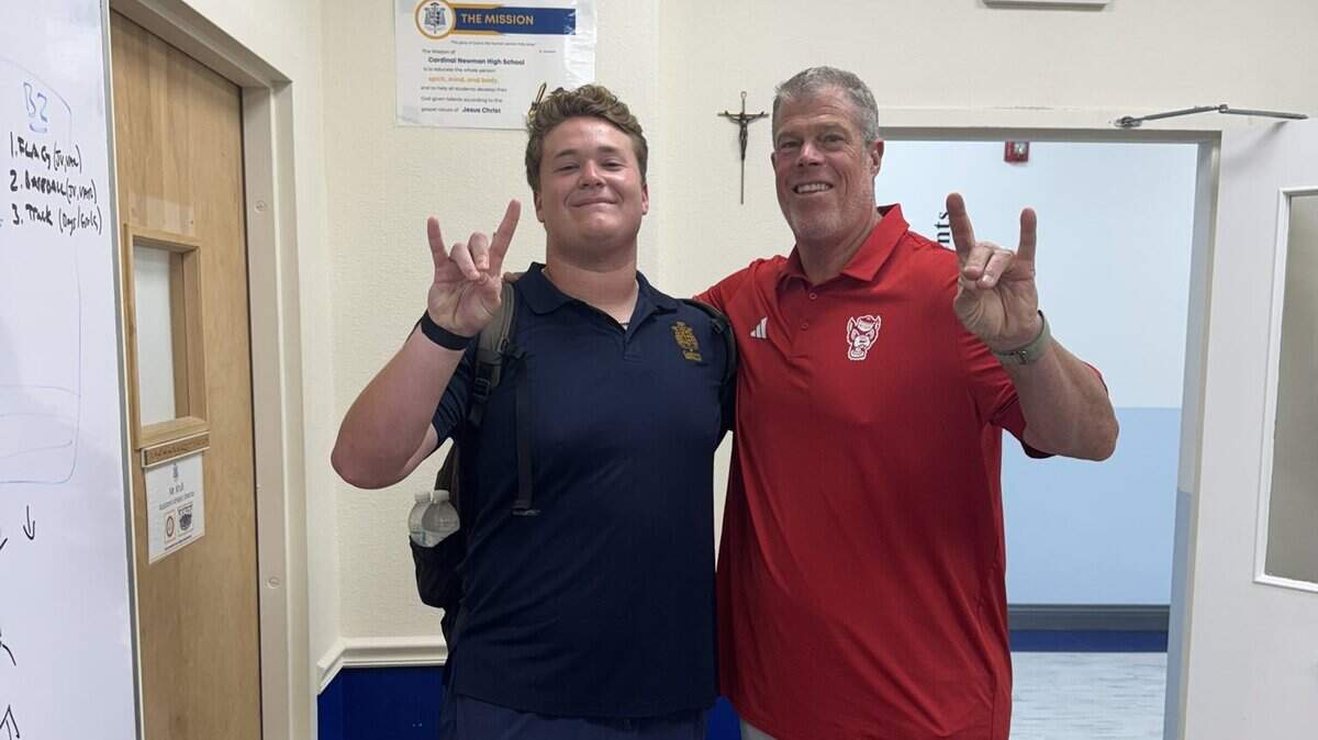 N.C. State commit Colt Hauser takes a photo with offensive line coach Garett Tujague during a visit in May.