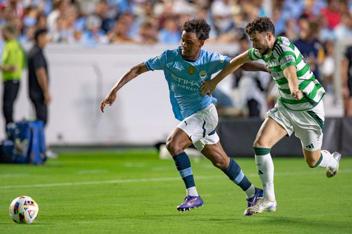 Manchester City midfielder Oscar Bobb (52) and Celtic FC forward Mikey Johnston (90) fight for the ball during the Celtic FC vs Manchester City at Kenan Stadium in Chapel Hill on Tuesday, July 23, 2024. Celtic FC won 4-3.