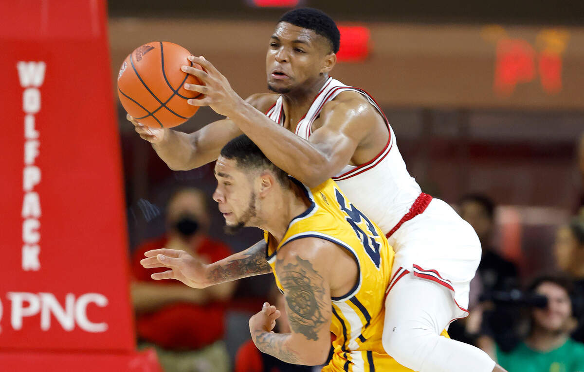 N.C. State’s Casey Morsell (14) pulls in the ball over Coppin State’s Isaiah Gross (25) during the first half of N.C. State’s game against Coppin State at Reynolds Coliseum in Raleigh, N.C., Tuesday, Dec. 6, 2022.