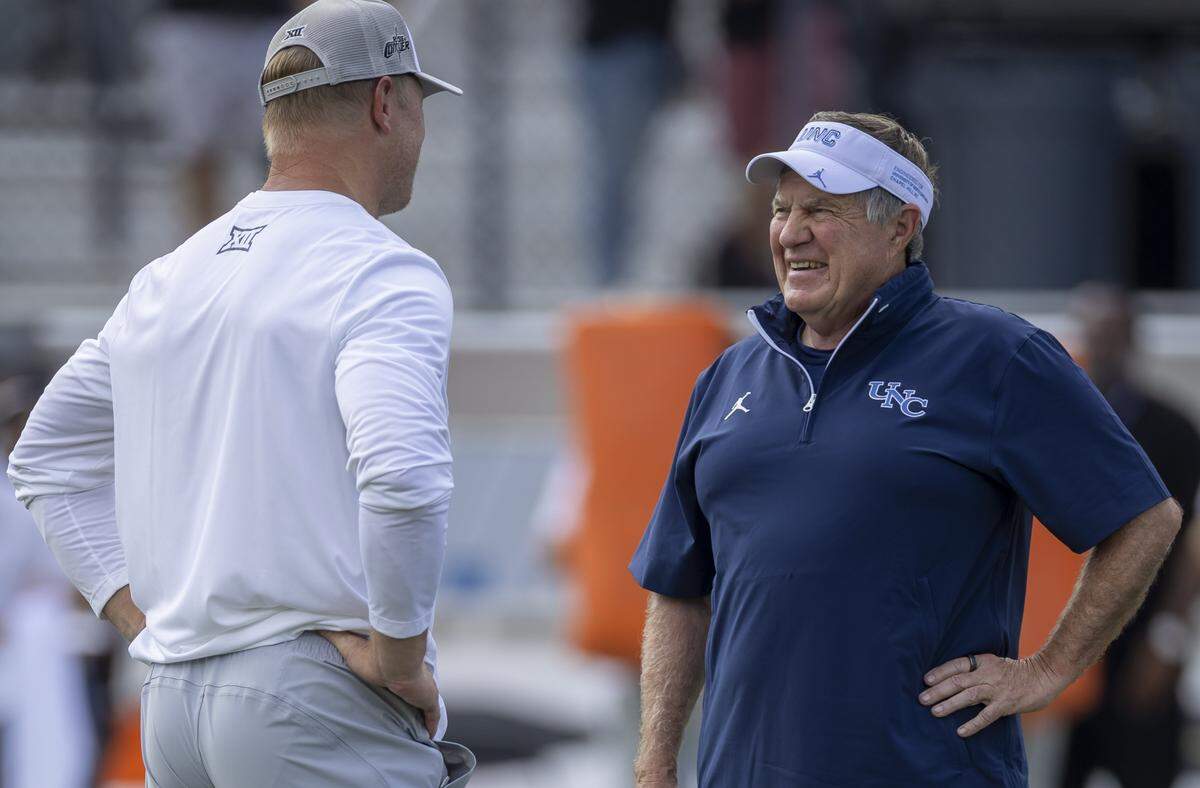 North Carolina coach Bill Belichick talks with UCF head coach Scott Frost prior to the Tar Heels’ game against UCF on Saturday, September 20, 2025 at Acrisure Bounce House Stadium in Orlando, Fla.
