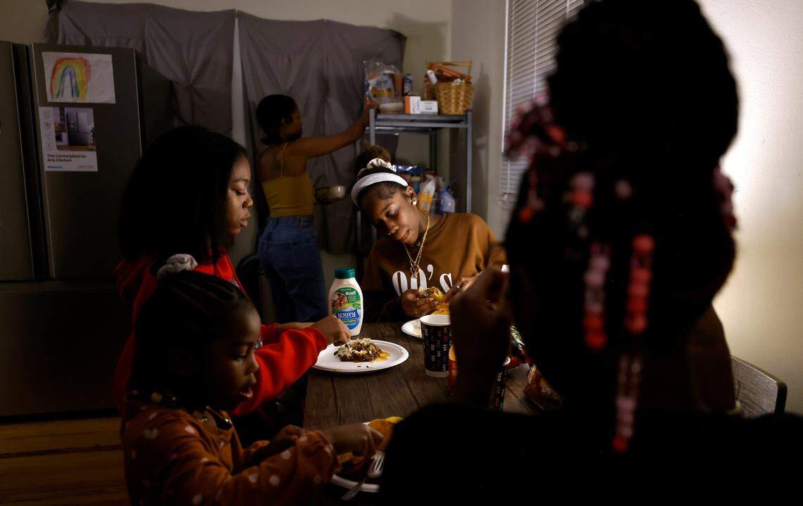 Sheba Everett and four of her daughters, from left, Hannah, 5, Sarah, 15, Ahava, 16, and Abby, 12, eat dinner together at their home in Durham, N.C. on Wednesday, Oct. 27, 2022. After renting the house for over two years, Everett received a notice to vacate by May 31, 2023. The Eno River Association, which owns this home and six others nearby, plans to transfer the property to the state.