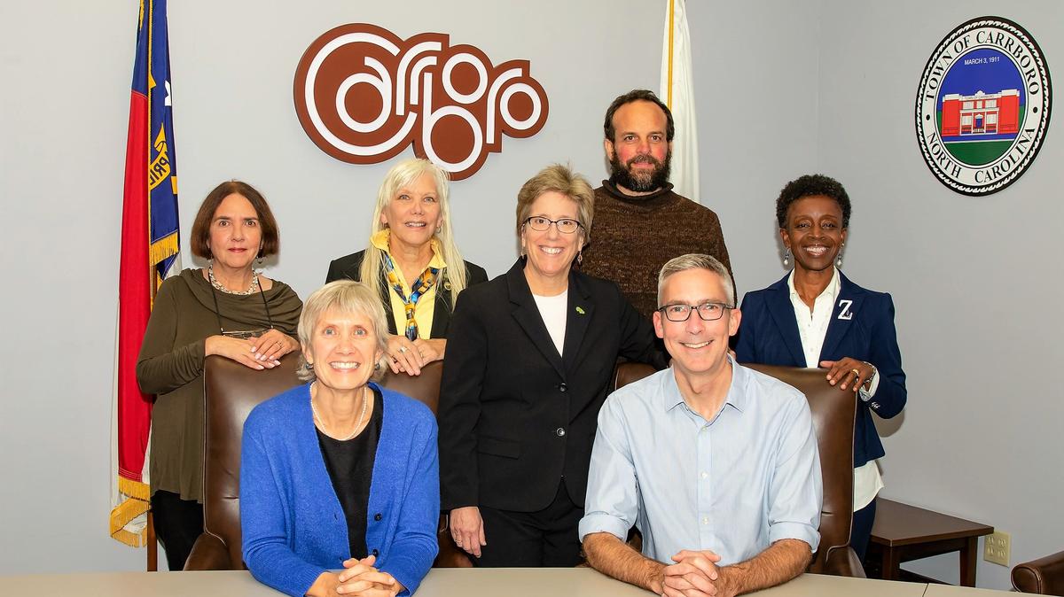 Carrboro’s Town Council -- Jacqueline Gist (standing, from left), Randee Haven-O’Donnell, Mayor Lydia Lavelle, Sammy Slade, Barbara Foushee, Susan Romaine (sitting, from left) and Damon Seils -- reviewed a draft 2020-21 budget Tuesday.