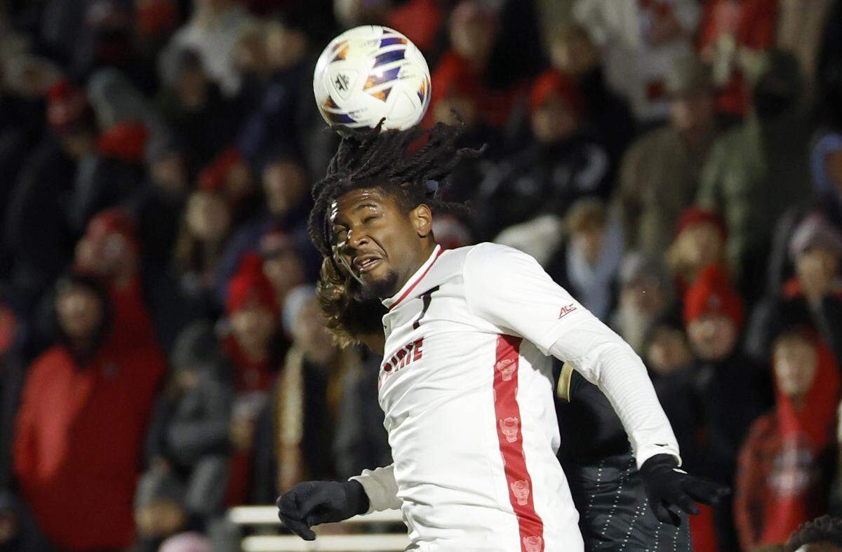 N.C. State's Donavan Phillip (7) heads the ball during the first half of N.C. State’s game against Washington in the 2025 Men’s Soccer National Championship at WakeMed Soccer Park in Cary, N.C., Monday, Dec. 15, 2025.