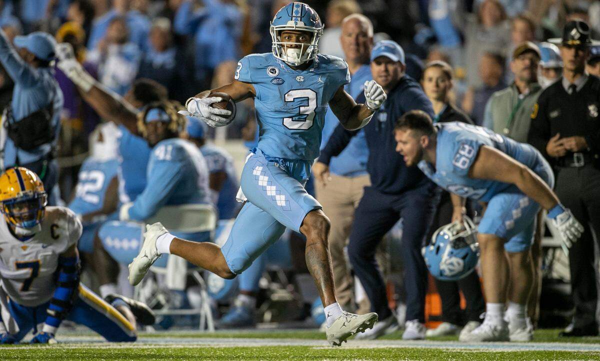 North Carolina’s Antoine Green (3) looks for running room on a 50-yard gain after a pass reception from quarterback Drake Maye in the second quarter on Saturday, October 29, 2022 at Kenan Stadium in Chapel Hill, N.C.
