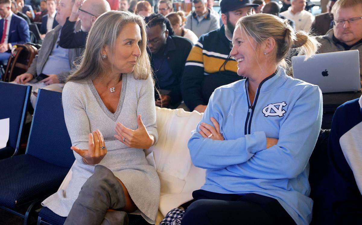 UNC Board of Trustees member Jennifer Lloyd talks with women’s basketball coach Courtney Banghart before a press conference for new North Carolina head football coach Bill Belichick at the Loudermilk Center for Excellence at UNC in Chapel Hill, N.C., Thursday, Dec. 12, 2024.