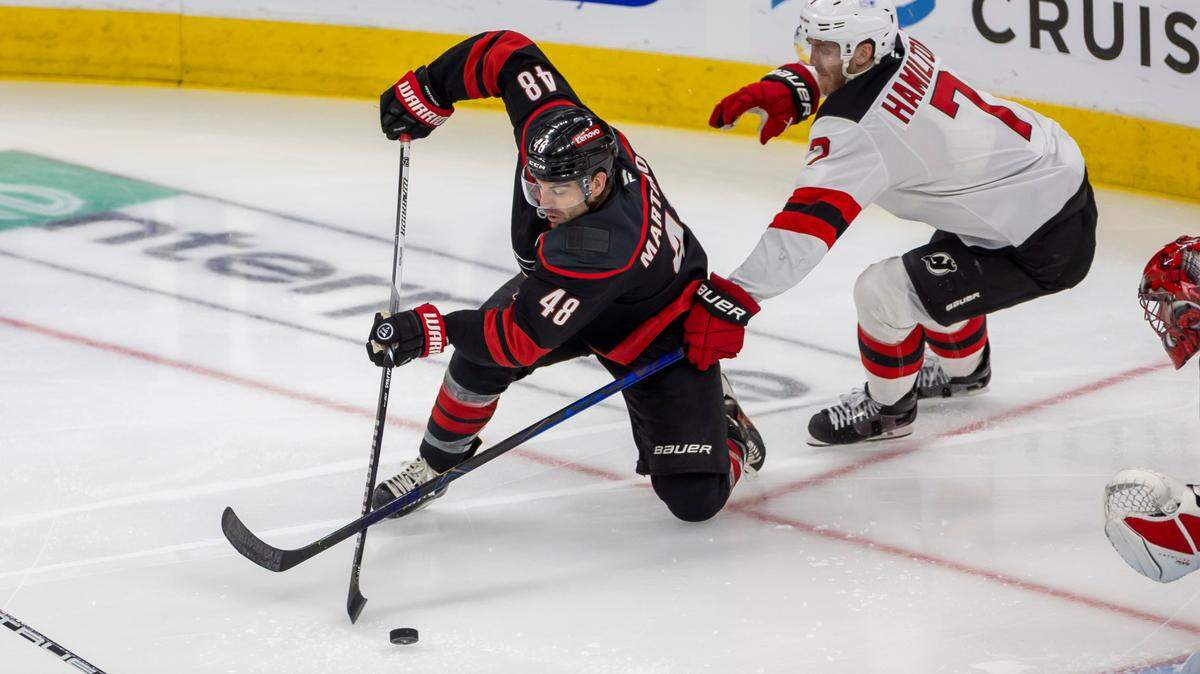 Carolina Hurricanes left wing Jordan Martinook (48) works against New Jersey Devils’ defenseman Dougie Hamilton (7) in the second period during game two of their Stanley Cup playoff series on Tuesday, April 22, 2025 at Lenovo Center in Raleigh, N.C.