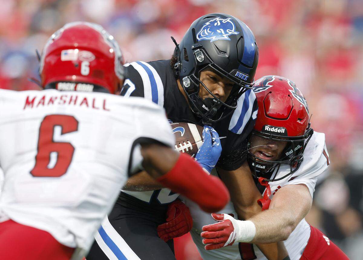 Duke’s Nate Sheppard carries the ball past N.C. State’s Devon Marshall and Caden Fordham during the first half of the Blue Devils’ game on Saturday, Sept. 20, 2025, at Wallace Wade Stadium in Durham, N.C.