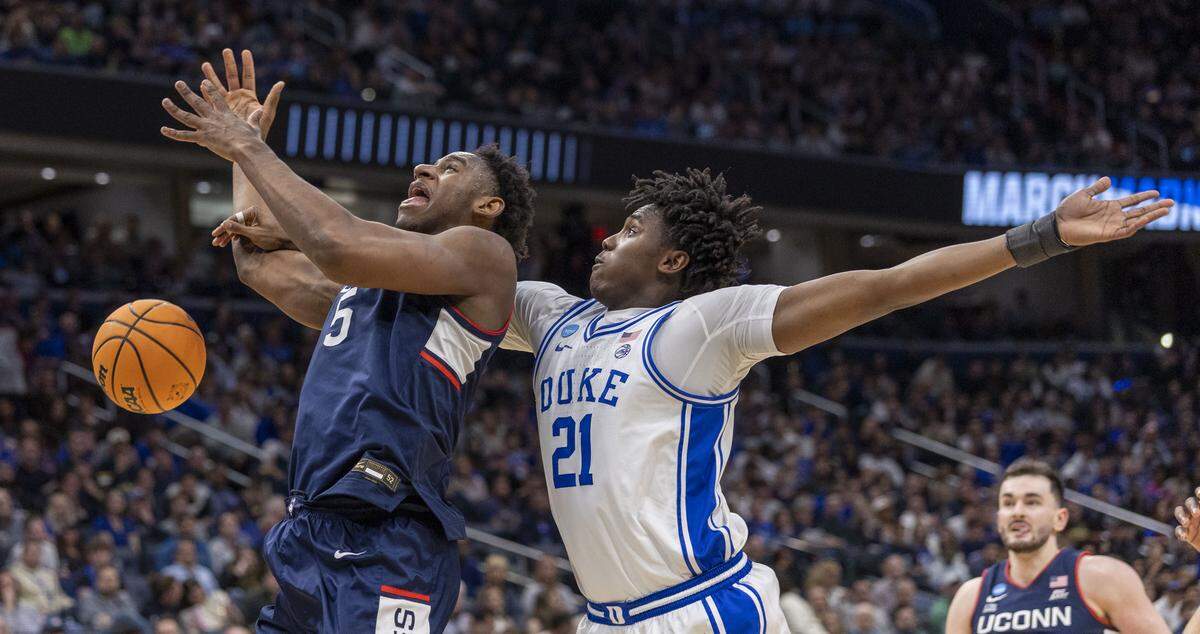 Connecticut forward Tarris Reed Jr. (5) draws a foul from Duke center Patrick Ngongba II (21) in the second half on Sunday, March 29, 2026, in the NCAA East Regional Championship, at Capital One Arena in Washington, D.C.