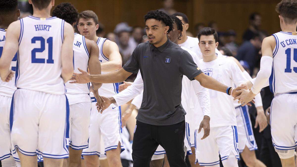 Duke’s Tre Jones (3) greets his teammates during a time out in the first half against Brown on Saturday, December 28, 2019 at Cameron Indoor Stadium in Durham, N.C. Jones is out with an injury to his left foot.