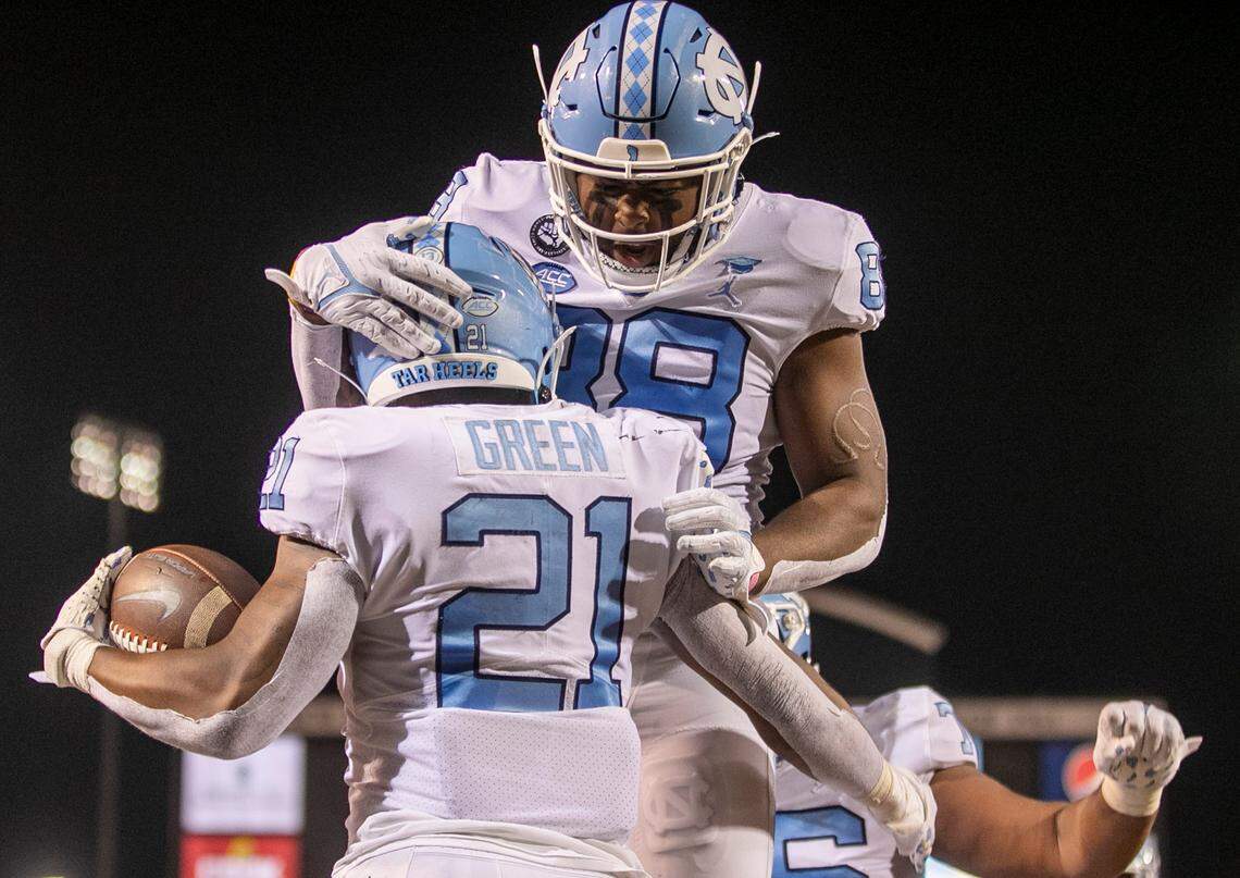 North Carolina’s Elijah Green (21) celebrates with teammate Asim Richards (72) after scoring a touchdown in the first quarter against Wake Forest on Saturday, November 12, 2022 at Truist Field in Winston-Salem, N.C.