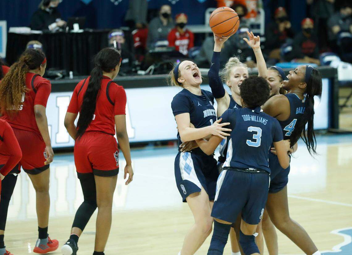North Carolina’s Alyssa Ustby (1), Kennedy Todd-Williams (3), Janelle Bailey (44), Petra Holesinska (2) and Stephanie Watts (5) celebrate after UNC’s 76-69 victory over N.C. State at Carmichael Arena in Chapel Hill, N.C., Sunday, February 7, 2021.