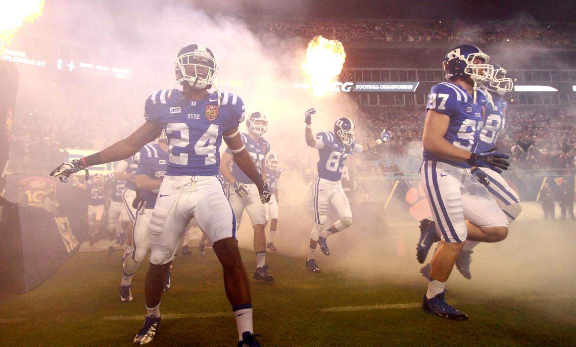 The Blue Devils run onto the field during before Duke’s game against Florida State in the ACC Football Championship in Charlotte in 2013.