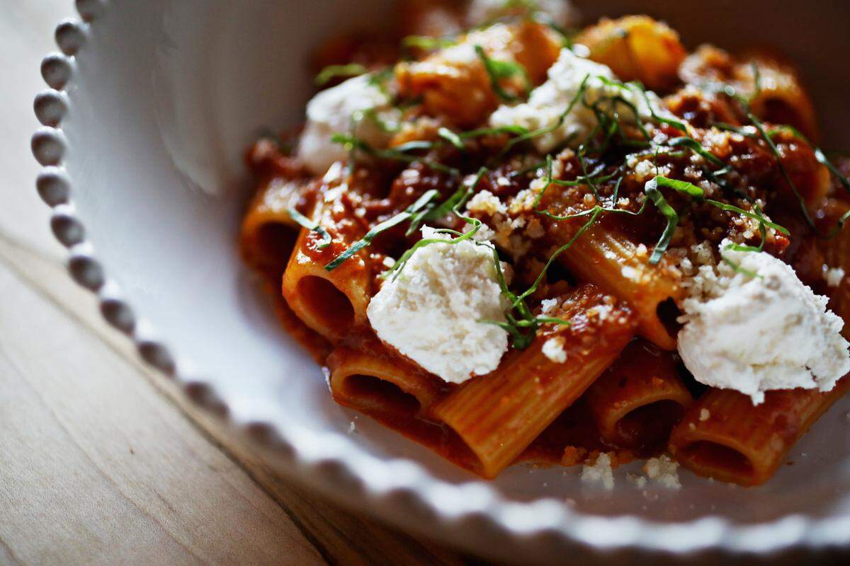 The spicy vodka tomato cream rigatoni is served with diced tomatoes, double cream and ricotta at Cucciolo Osteria in Durham.  