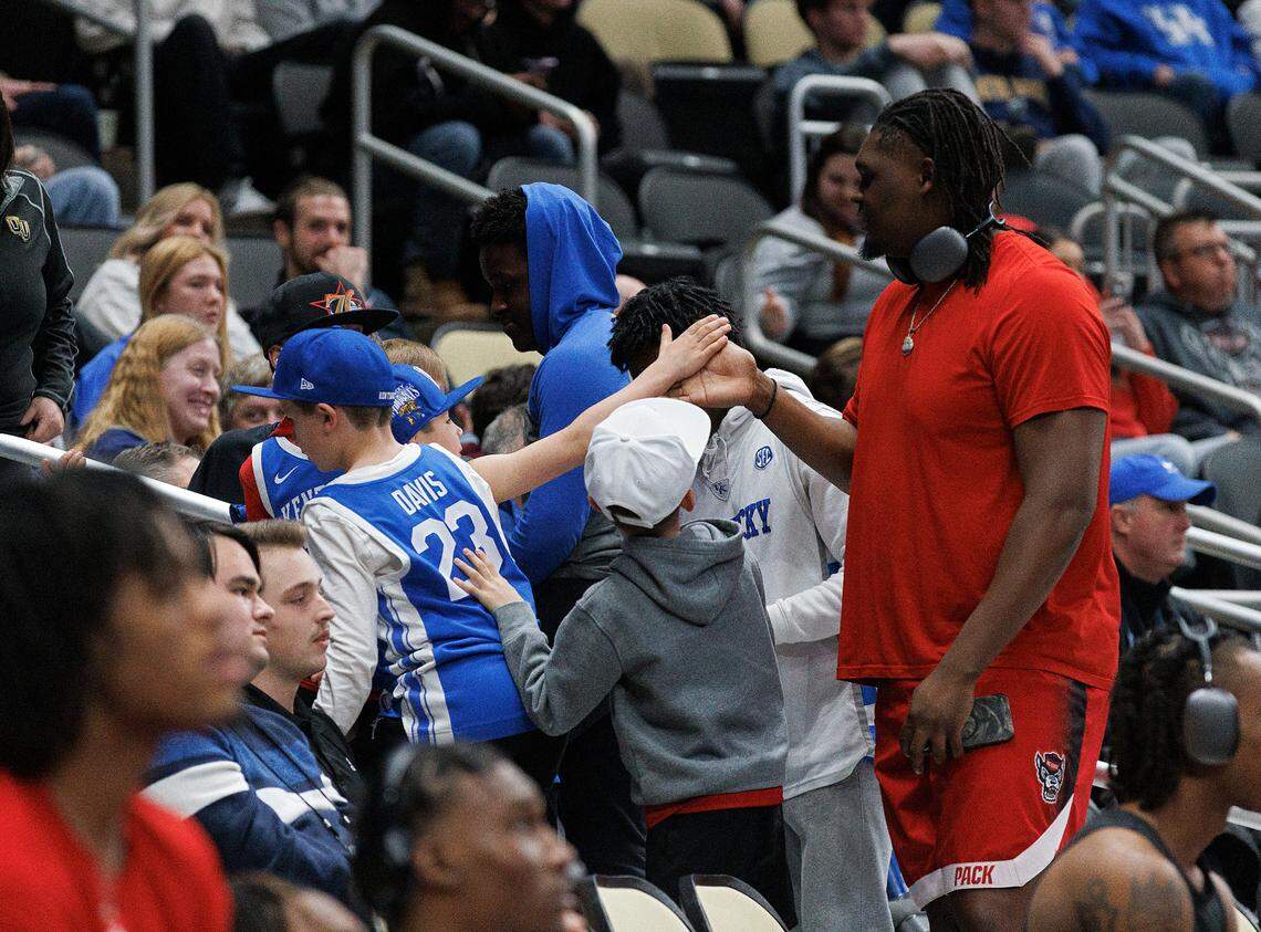 N.C. State’s DJ Burns Jr. gets a high-five from a young Kentucky fan prior to the Wolfpack’s first round NCAA Tournament game against Texas Tech on Thursday, March 21, 2024, at PPG Paints Arena in Pittsburgh, Pa.