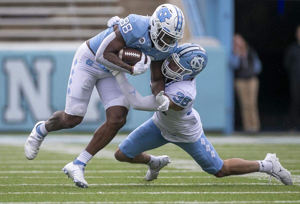 North Carolina’s Val Edwards (38) works to stop receiver Kamari Morales (88) during the Tar Heels’ spring football game on Saturday, April 9, 2022 at Kenan Stadium in Chapel Hill, N.C.