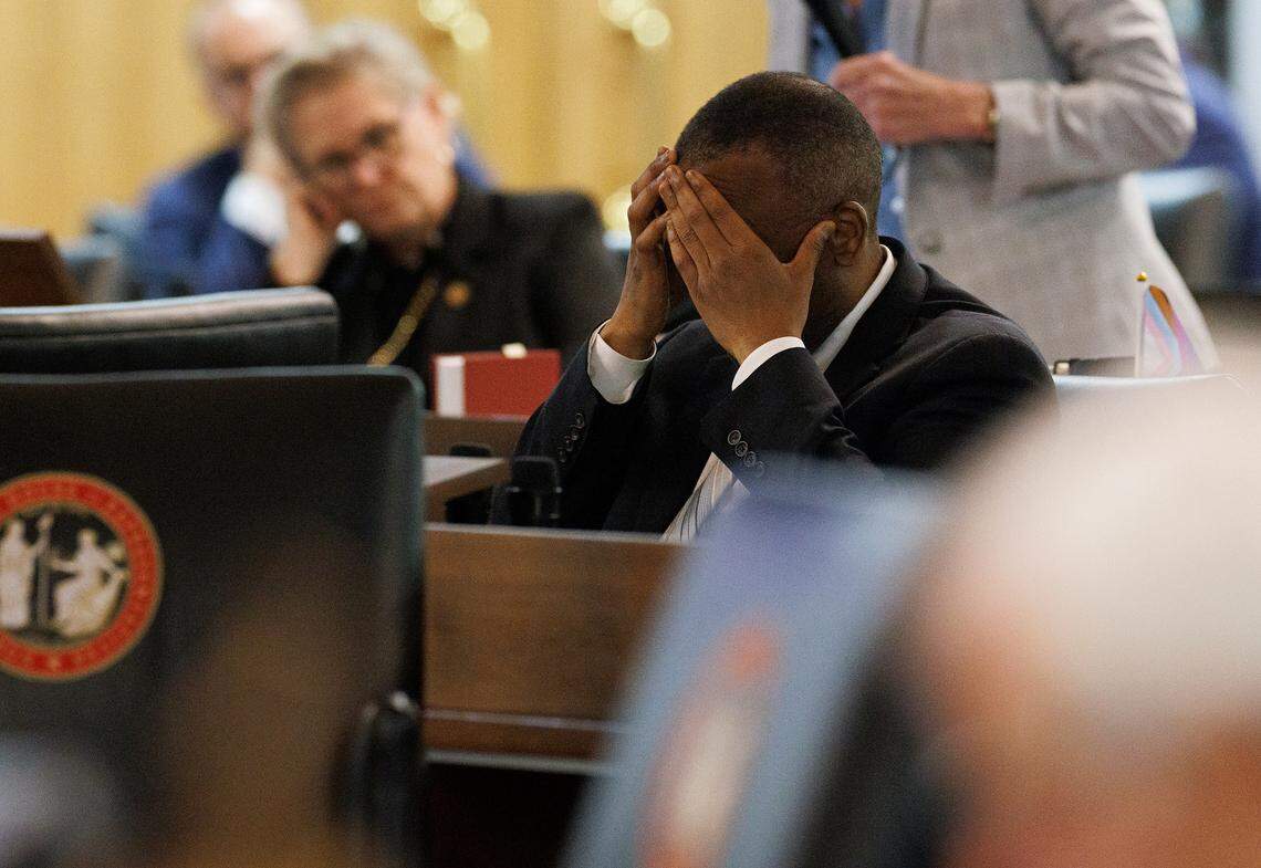 Rep. Robert Reives covers his face with his hands as a bill including a series of power shifts is debated during a legislative session at the General Assembly on Tuesday, Nov. 19, 2024, in Raleigh, N.C.