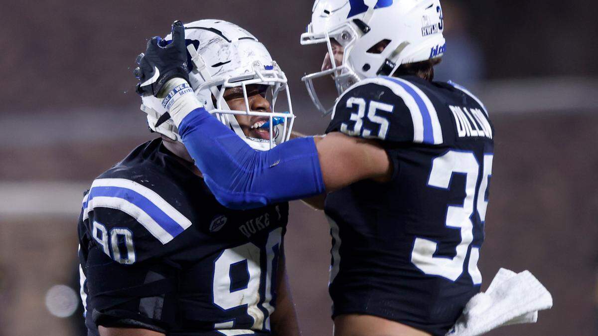 Duke’s DeWayne Carter celebrates with Cam Dillon after sacking Wake Forest quarterback Sam Hartman during the second half of the Blue Devils’ final regular season game at Wallace Wade Stadium on Saturday, Nov. 26, 2022, in Durham, N.C.