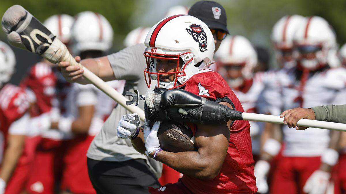 N.C. State’s Jayden “Duke” Scott (4) runs drills during the Wolfpack’s first fall practice Wednesday, July 30, 2025.