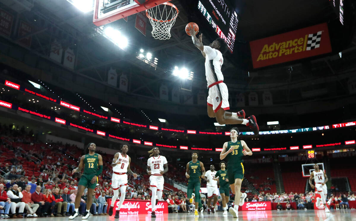 N.C. State’s Jarkel Joiner (1) makes the alley-oop on a pass from Terquavion Smith (0) during N.C. State’s 85-64 victory over William & Mary at PNC Arena in Raleigh, N.C., Tuesday, Nov. 29, 2022.