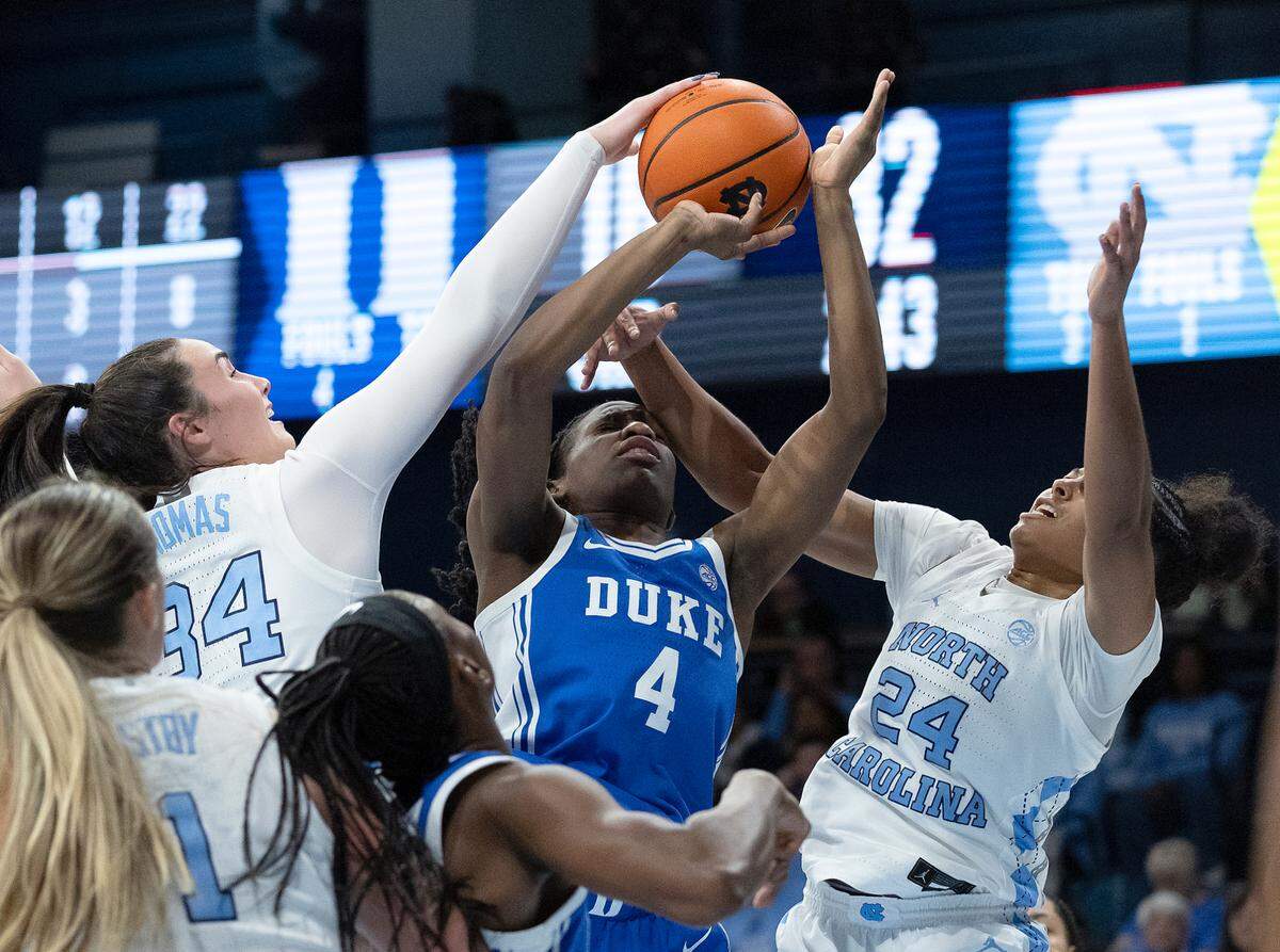North Carolina’s Blanca Thomas and Indya Nivar contest a shot by Duke’s Jadyn Donovan during the second half of the Tar Heels’ 53-46 overtime win on Thursday, Jan. 9, 2025, at Carmichael Arena in Chapel Hill, N.C.