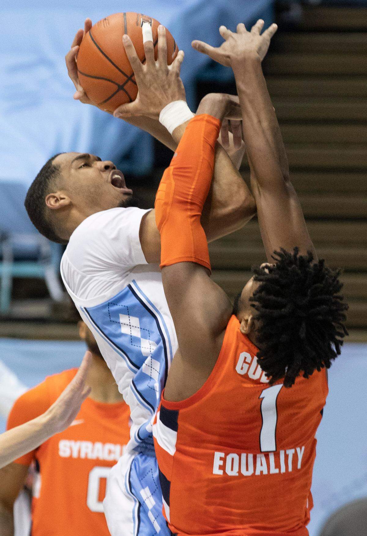 North Carolina’s Garrison Brooks (15) muscles his way to the basket against Syracuse’s Quincy Guerrier (1) during the first half on Tuesday, January 12, 2021 at the Smith Center in Chapel Hill, NC.