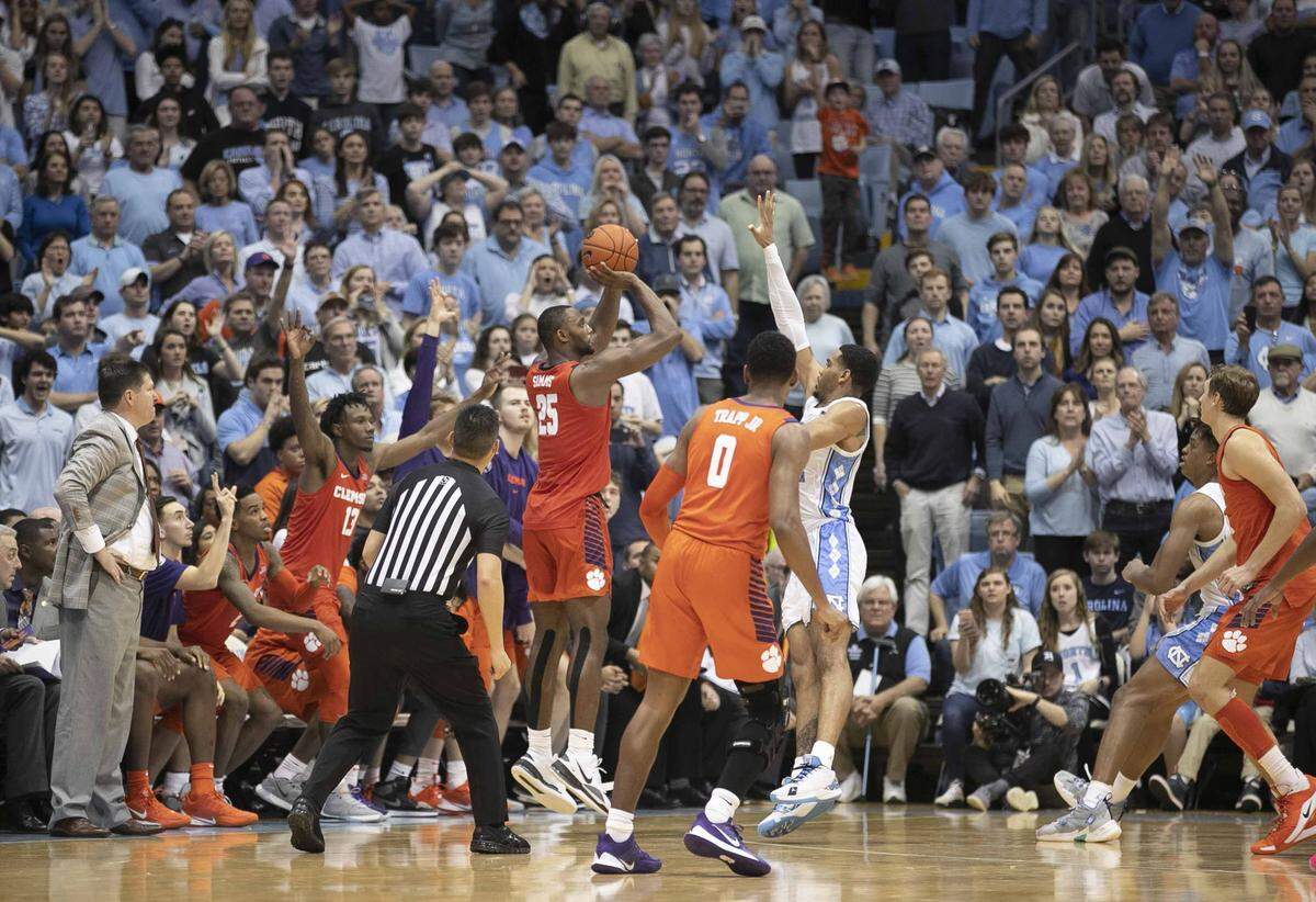 Clemson’s Aamir Simms (25) launches a three-point shot over North Carolina’s Garrison Brooks (15) with :03 seconds to play in regulation to tie the score at 70-70 and force overtime on Saturday, January 11, 2020 at the Smith Center in Chapel Hill, N.C.