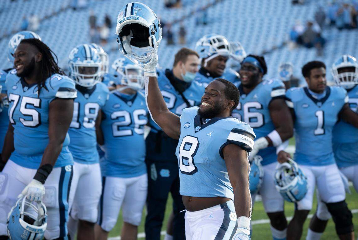 North Carolina’s Michael Carter (8) and his teammates celebrate their 59-53 victory over Wake Forest at Kenan Stadium on Saturday, November 14, 2020 in Chapel Hill, N.C.