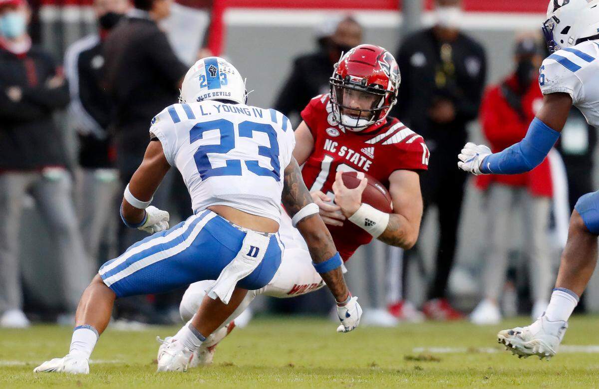 Duke safety Lummie Young IV (23) prepares to hit N.C. State quarterback Devin Leary (13) as Leary slides during the second half of N.C. State’s 31-20 victory over Duke at Carter-Finley Stadium in Raleigh, N.C., Saturday, Oct. 17, 2020. Leary was injured on the play and Young was called for targeting and ejected from the game.