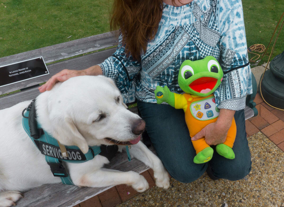 Susan Osborn sits with her son Noah’s service dog Saxby and her son’s favorite toy. Noah is a 17 year old with autism and other developmental disabilities, who stays in an intermediate care facility. Susan hasn’t seen him in more than two months. “I don’t know if he thinks ‘Mom and dad don’t want to see me,’” she said.