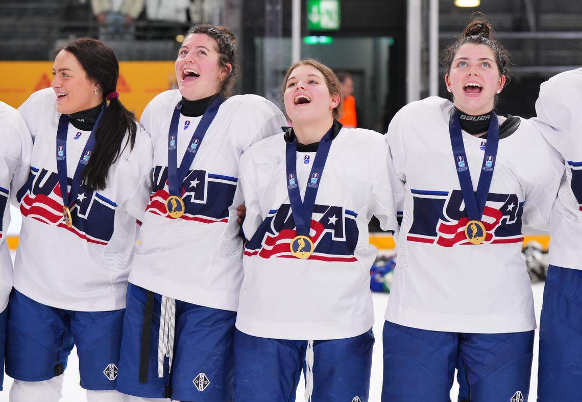 Mary Derrenbacher, second from right, sings the national anthem with USA Hockey teammates, from left, Kendra Distad, Kassidy Carmichael and Alanna Devlin after winning the gold medal over Czechia at the 2024 IIHF U18 Women’s World Championship in Switzerland in January.
