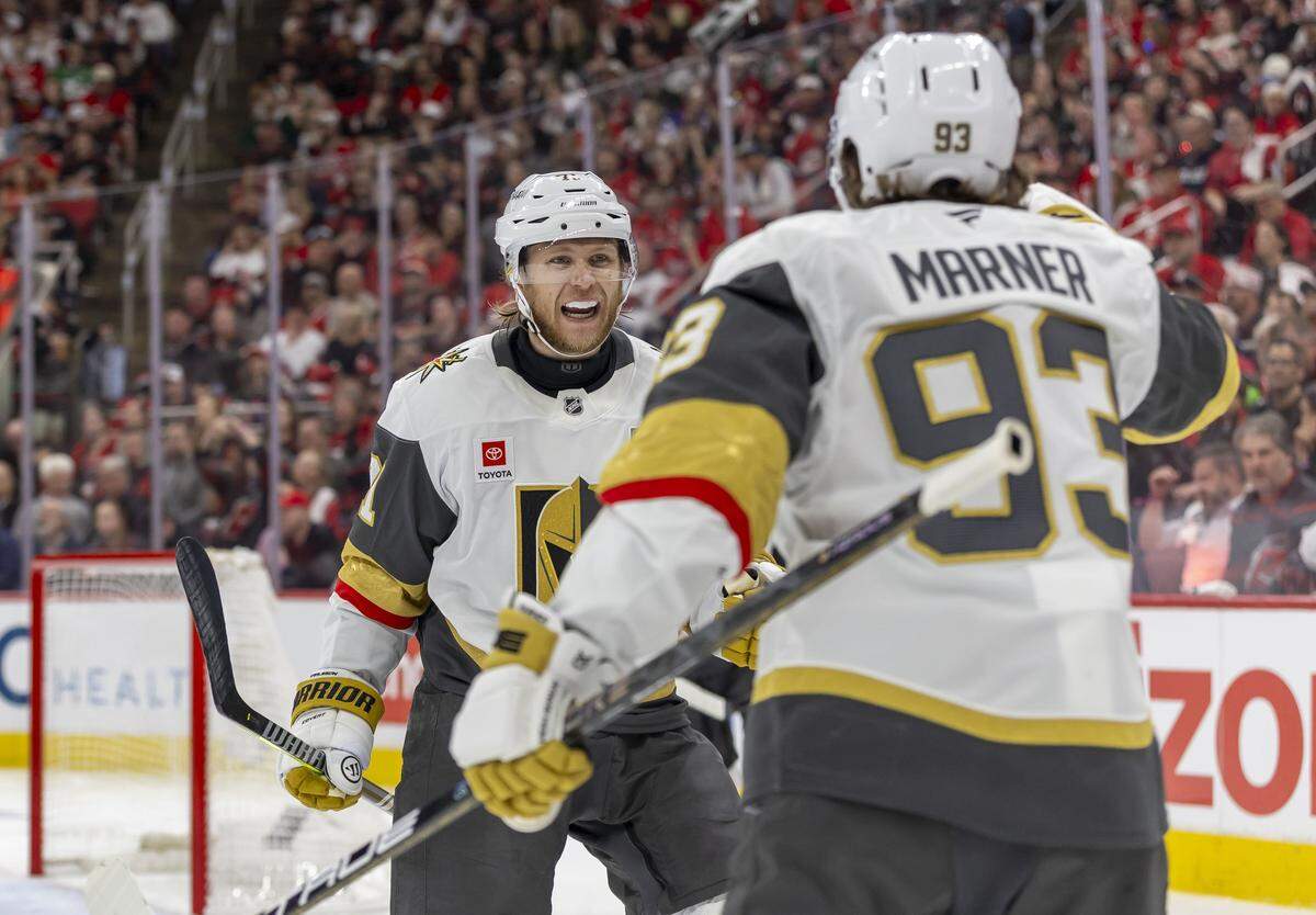 Las Vegas center William Karlsson (71) celebrates with teammate Mitch Marner (93)  after scoring to give the Knights a 3-2 lead in the second period against the Carolina Hurricanes in Game 1 of the Stanley Cup Finals, on Tuesday, June 2, 2026 at Lenovo Center in Raleigh, N.C.