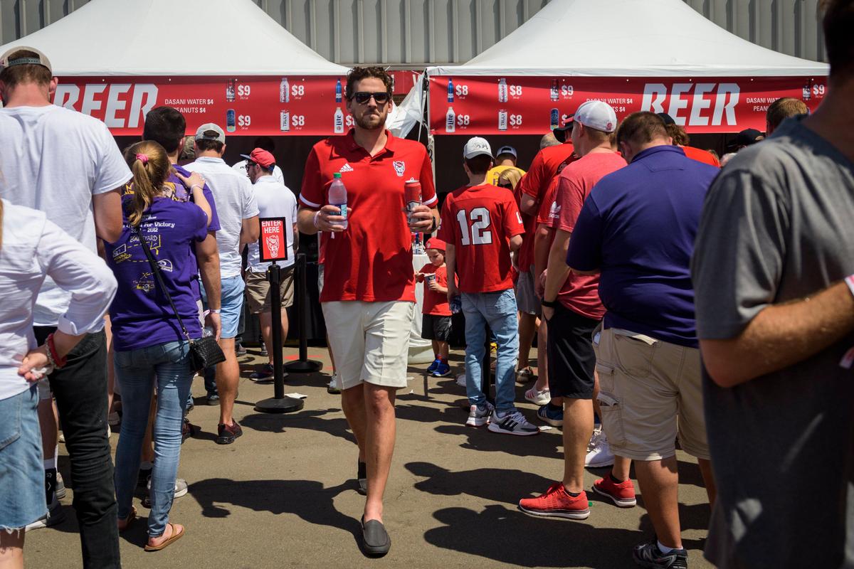 Matthew DiGioia, an NC State alum, buys an Old Tuffy beer at Carter Finley Stadium in Raleigh, NC on Aug 31, 2019. It is the first in the university’s history that beer is sold.