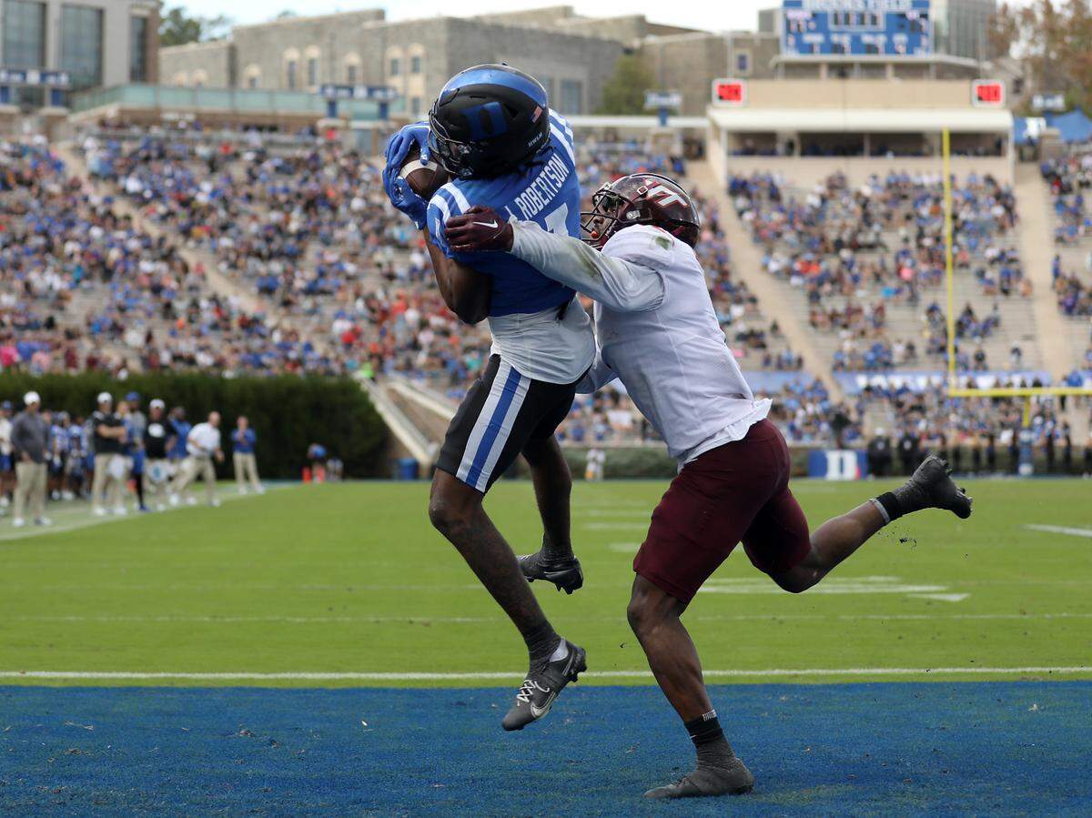 Duke wide receiver Jontavis Robertson catches a pass in the end zone over Virginia Tech defensive back Chamarri Conner to put the Blue Devils up 24-7 during the second half of a football game at Wallace Wade Stadium on Saturday, Nov. 12, 2022, in Durham, N.C.