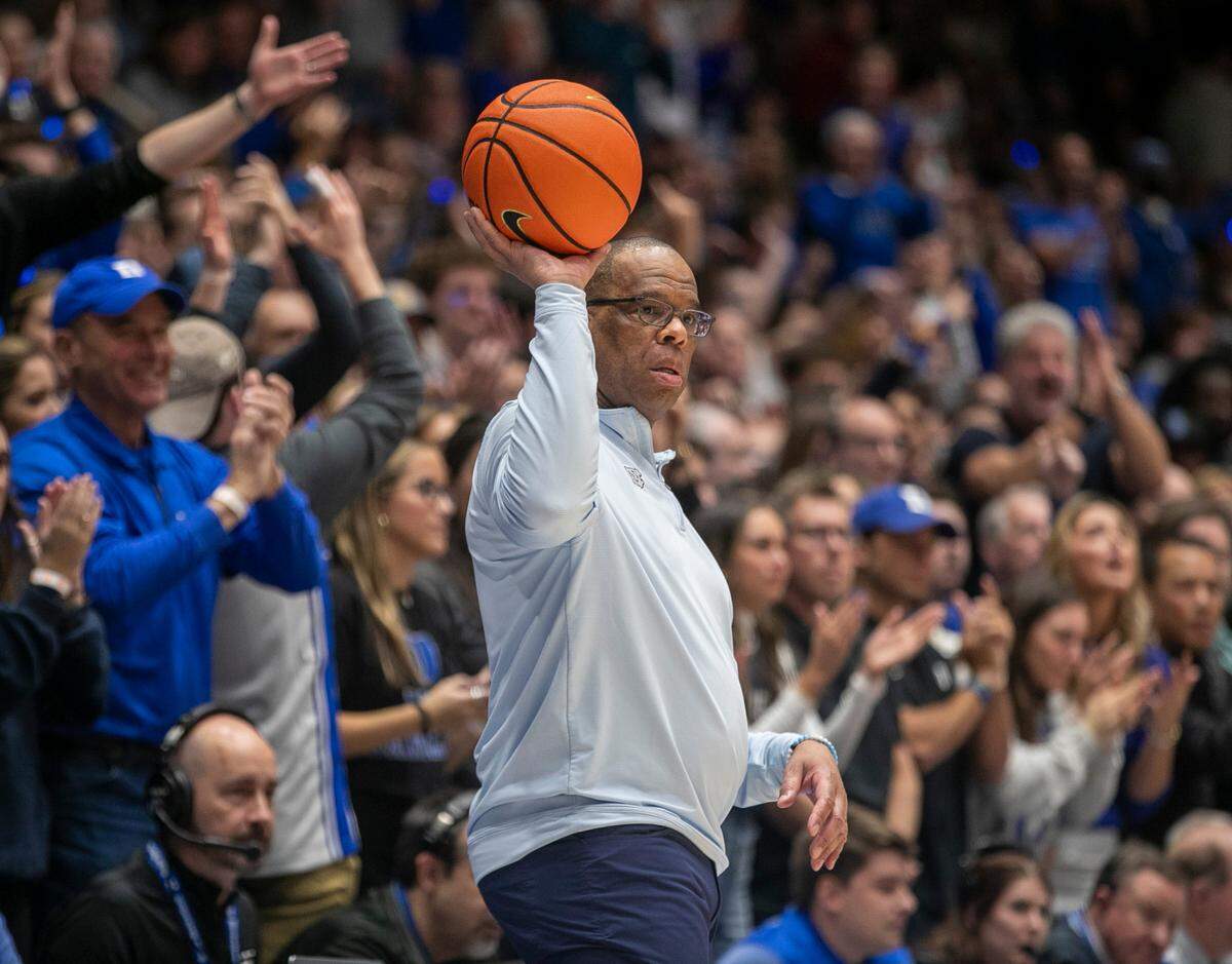 North Carolina coach Hubert Davis retrieves the ball after the Tar Heels lost it out of bounds in the second half against Duke on Saturday, February 4, 2023 at Cameron Indoor Stadium in Durham, N.C.