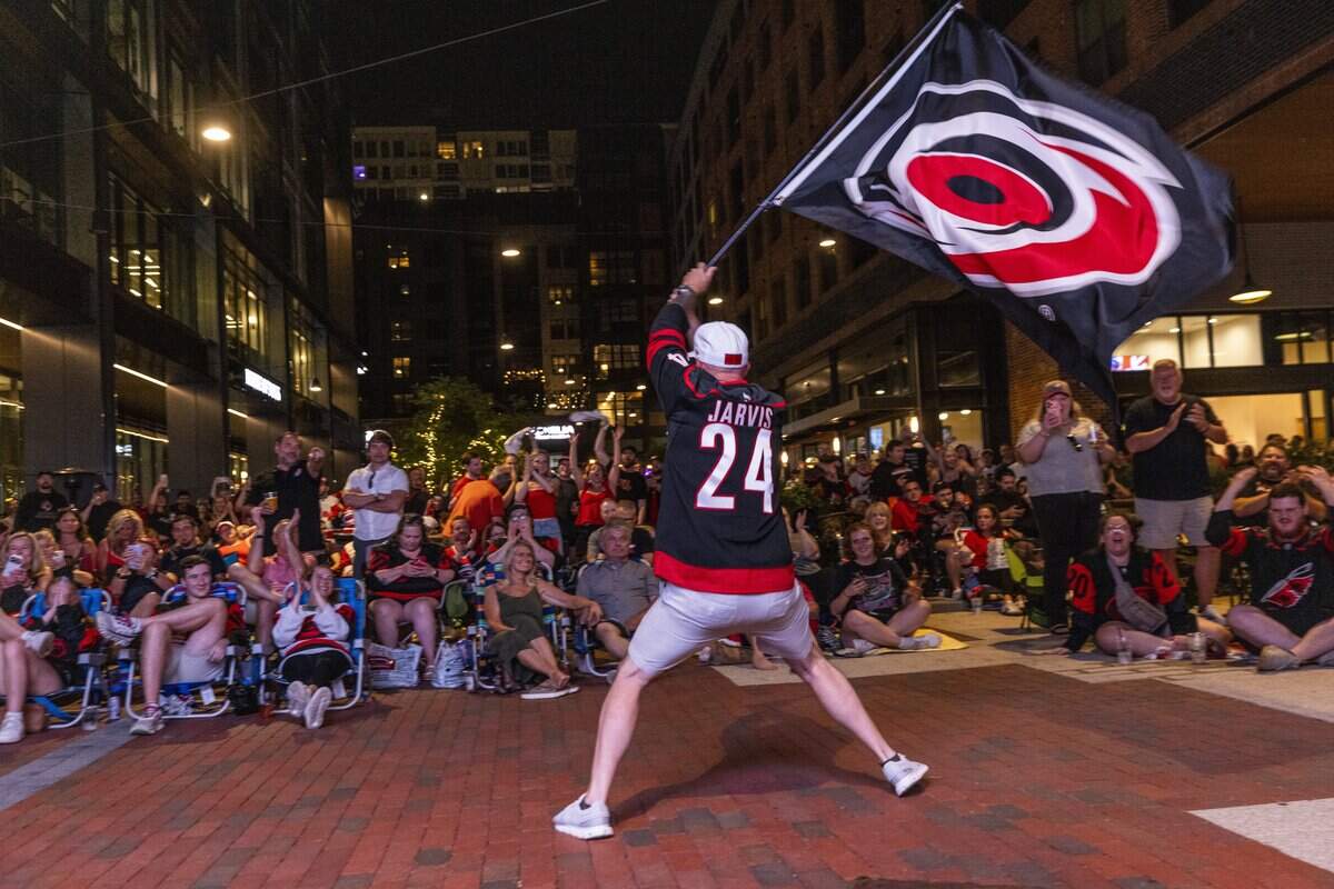 Carolina Hurricanes fans celebrate during an NHL Eastern Conference Final watch party in Raleigh's Smoky Hollow district on Friday, May 29, 2026. The Hurricanes advanced to the Stanley Cup Final with a 6-1 victory over the Montreal Canadiens at Lenovo Center in Raleigh, marking the franchise's first trip to the NHL championship series in 20 years.