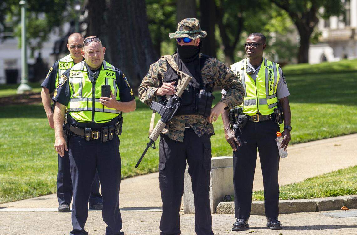 Adam Smith, an organizer with the ReOpen NC group is asked by Capitol Police to leave the State Capitol property while he demonstrated with group of about a half dozen mostly armed demonstrators affiliated with the Facebook group Blue Igloo as they marched in downtown Raleigh Saturday, May, 16, 2020.
