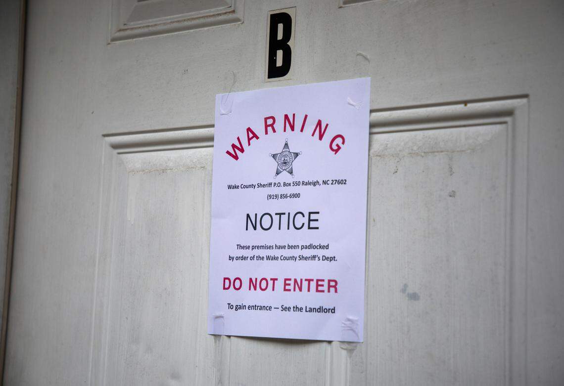 A padlock notice is taped to the door of an apartment, whose tenant was unavailable for comment, on Wednesday, Aug. 19, 2020, in Raleigh, N.C.