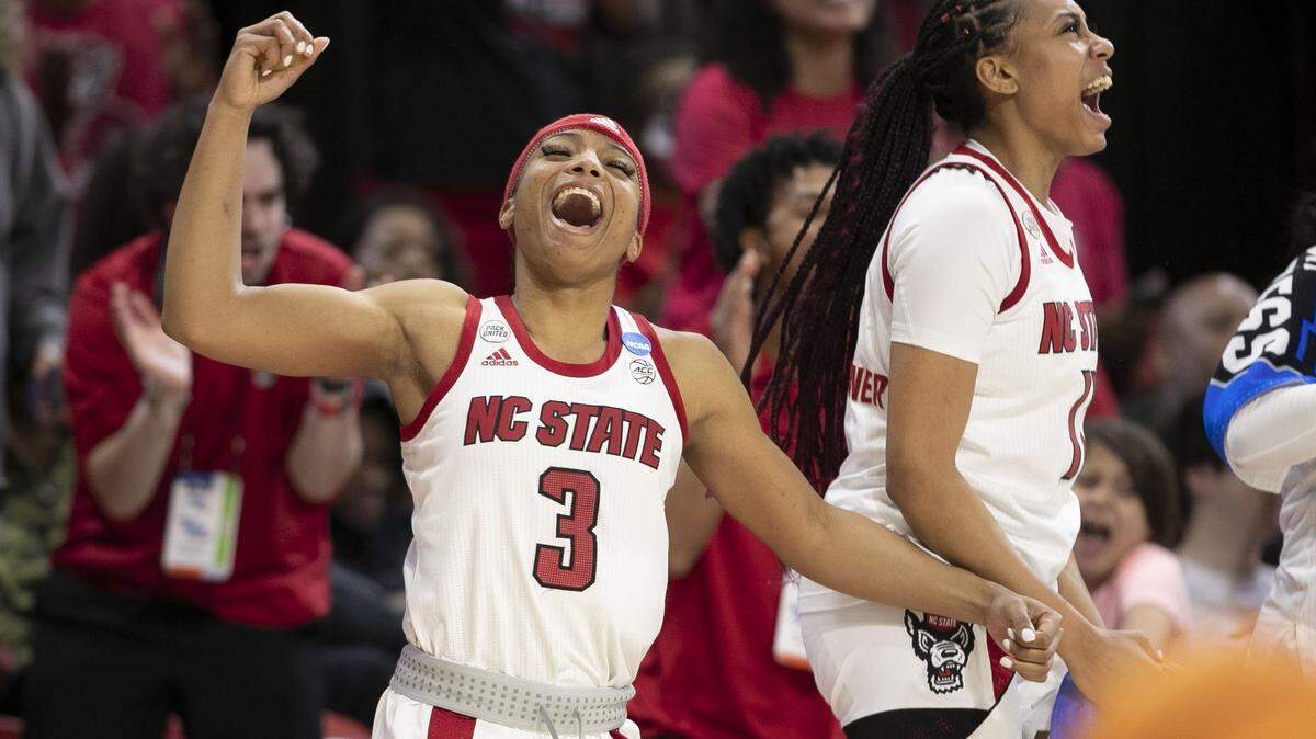 N.C. States Kai Crutchfield (3) and Jakia Brown-Turner (11) react after a basket by Sophie Hart (32) to secure an 89-57 victory over Kansas State during the second round of the NCAA Tournament on Monday, March 21, 2022 at Reynolds Coliseum in Raleigh, N.C.