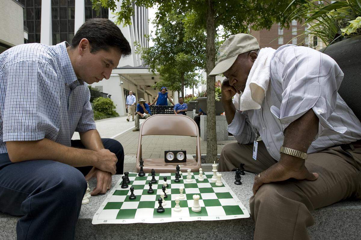 Sherman Leathers Jr., right, plays speed chess with Luis Guzman on Fayetteville Street. Leathers, a onetime president of the Raleigh Chess Club, lobbied to get the old stone chess tables, which had been located outside the Sir Walter Raleigh building, back on the sidewalk after years in a storage shed.