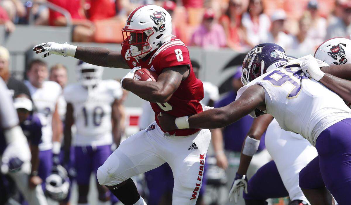 N.C. State running back Ricky Person Jr. (8) breaks free from Western Carolina defensive lineman K.J. Milner (96) during the first half of N.C. State’s game against Western Carolina at Carter-Finley Stadium in Raleigh, N.C., Saturday, Sept. 7, 2019.