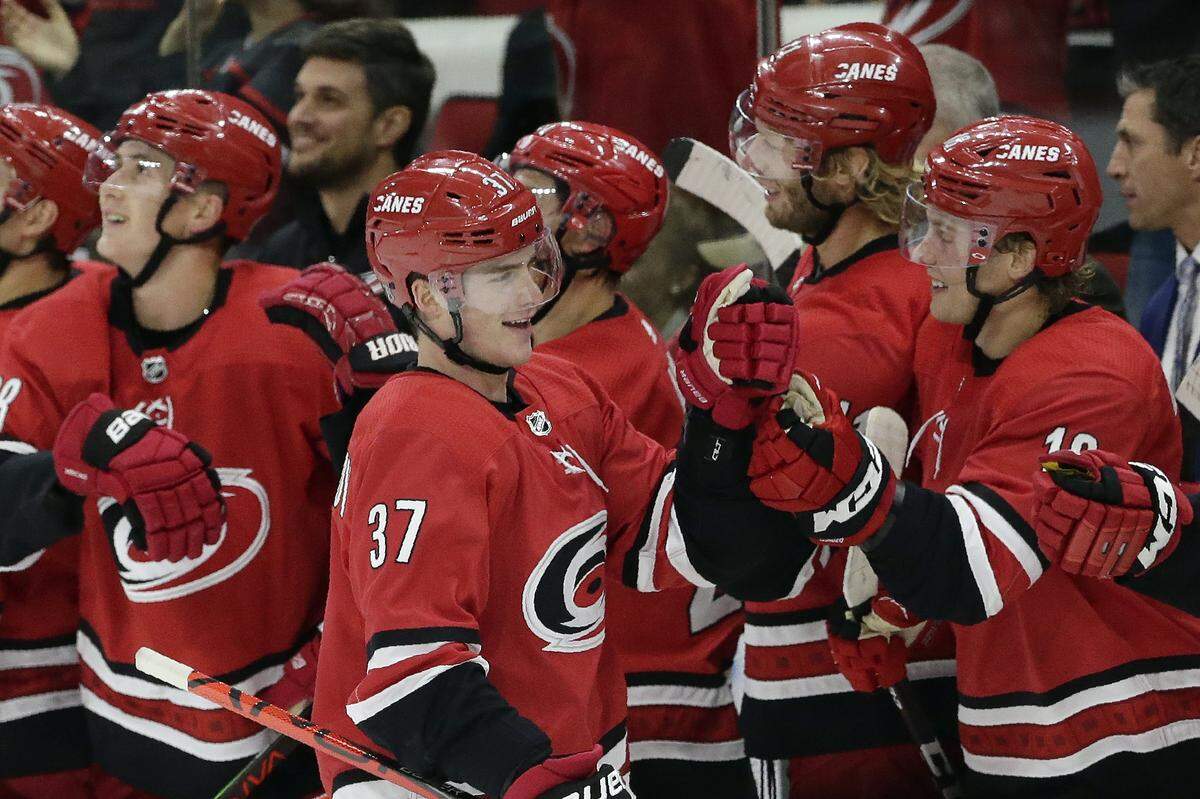 Carolina Hurricanes right wing Andrei Svechnikov (37), of Russia, celebrates with teammates following Svechnikov’s goal against the Calgary Flames during the third period of an NHL hockey game in Raleigh, N.C., Tuesday, Oct. 29, 2019. Carolina won 2-1. (AP Photo/Gerry Broome)