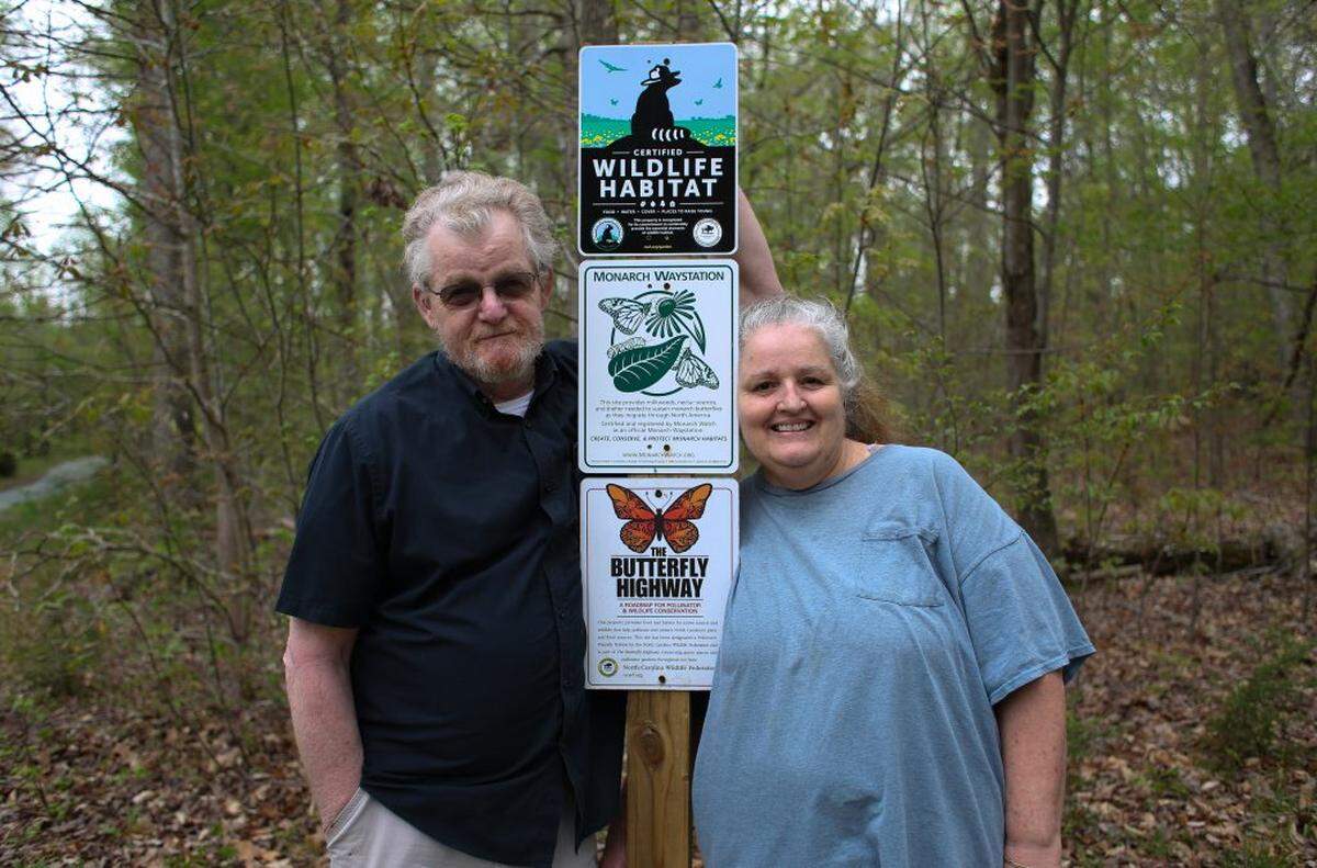 Bruce Taggart and Phyllis Simon pose for a photo outside their home in Hillsborough, North Carolina, “The Butterfly House.” Over the years, they’ve transformed their property into a certified wildlife habitat, monarch waystation and “pollinator pit stop” on the Butterfly Highway.