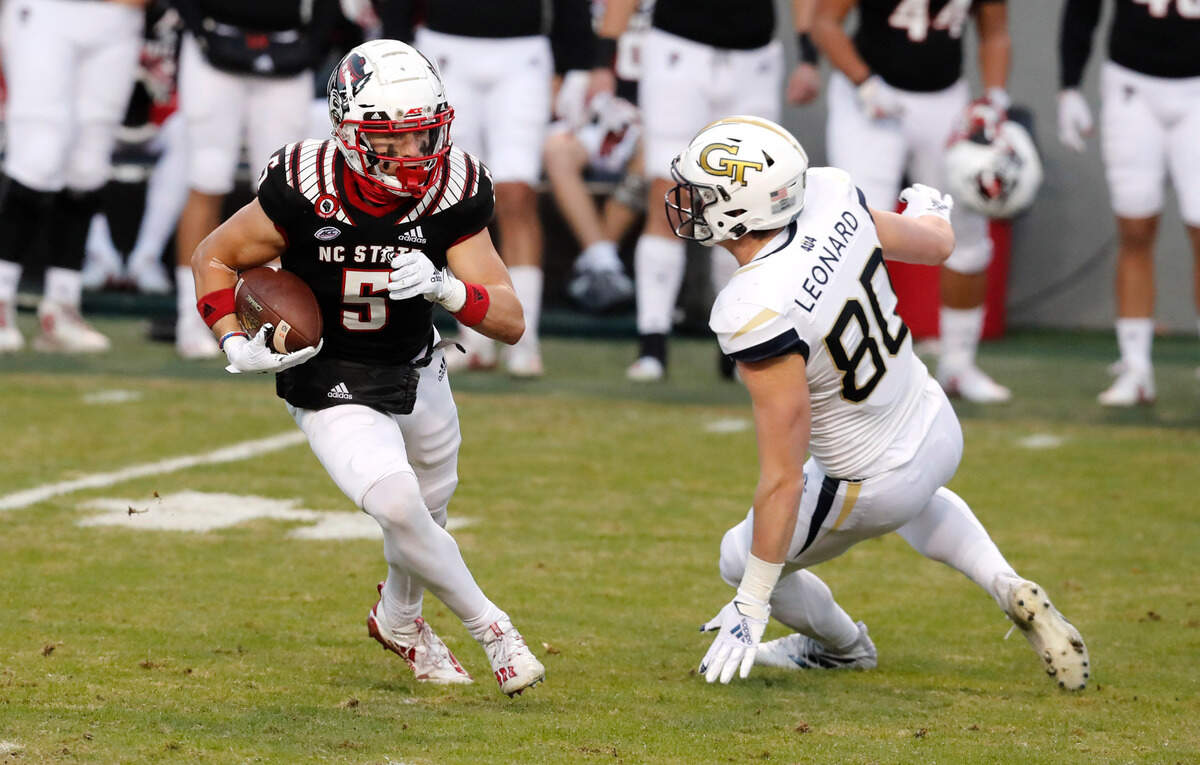 N.C. State’s Thayer Thomas (5) runs past Georgia Tech’s Dylan Leonard (80) during a punt return during the first half of N.C. State’s game against Georgia Tech at Carter-Finley Stadium in Raleigh, N.C., Saturday, Dec. 5, 2020.